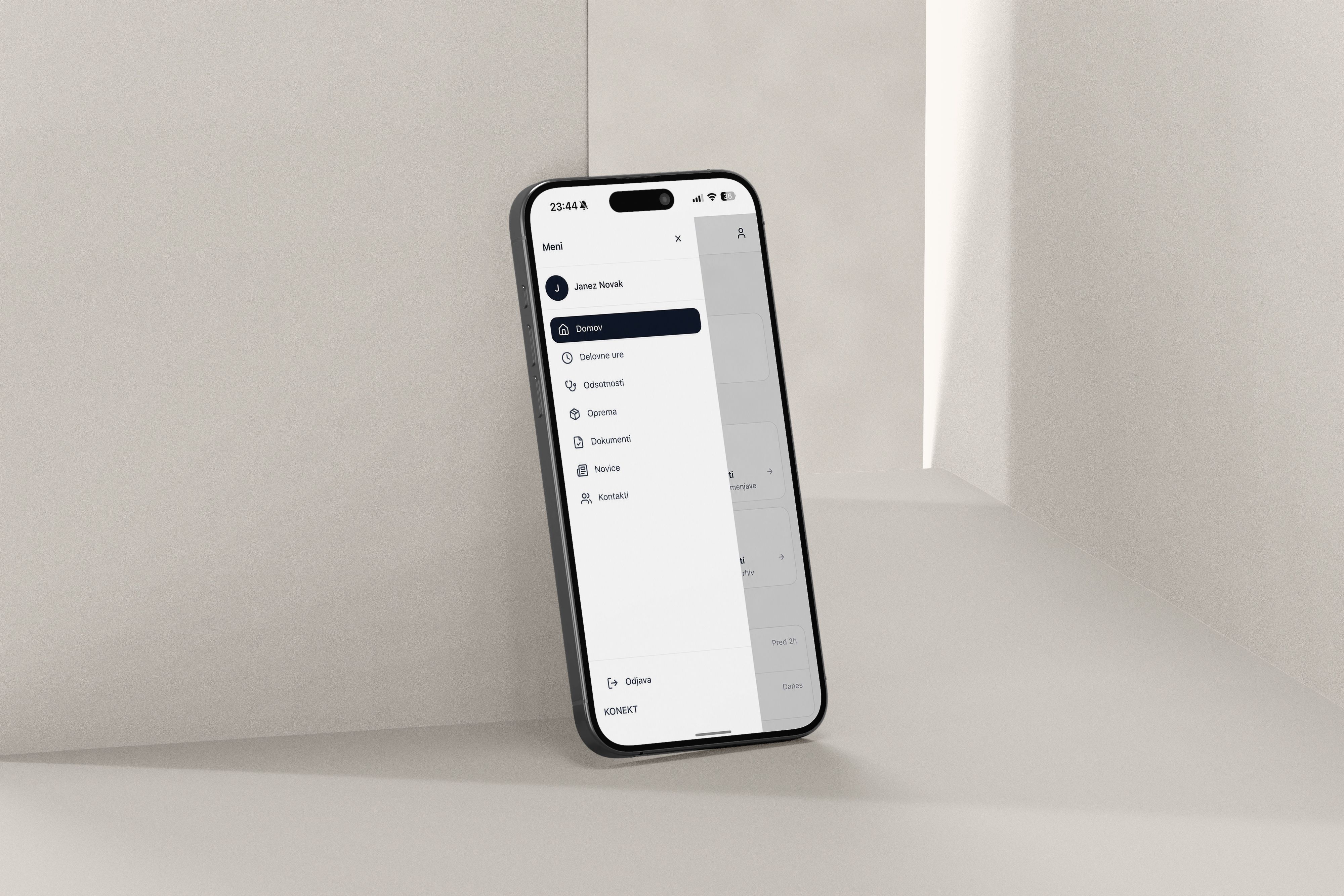 A modern smartphone with a dark interface and menu options leans against a light wall.